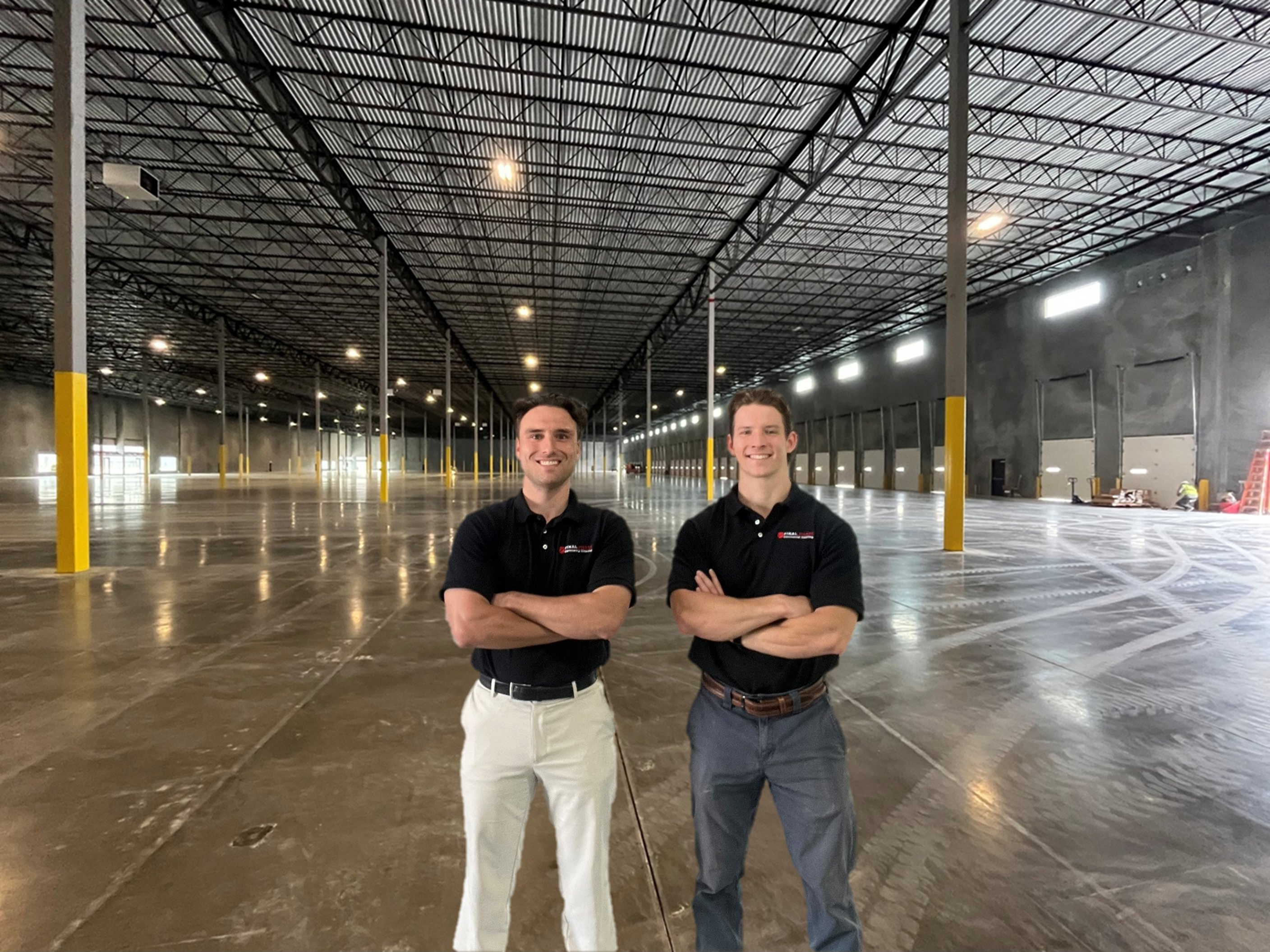 Final Phase Commercial Cleaning Solutions owners standing in a cleaned warehouse — Charlotte NC