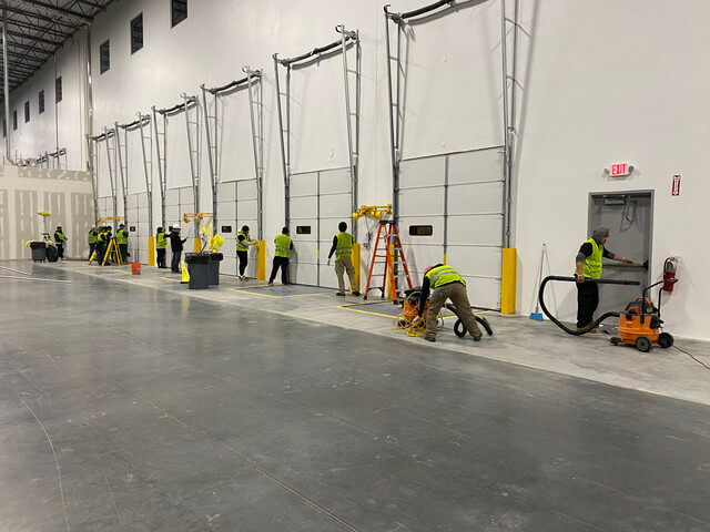 Post-construction cleanup crew working in warehouse facility Charlotte NC